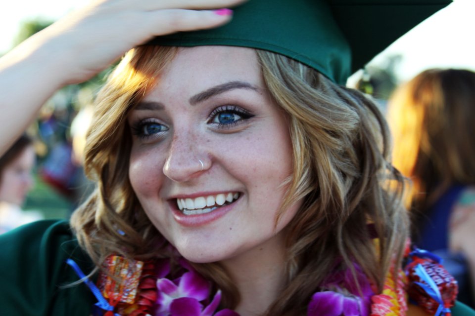 A smiling graduate wearing a mortarboard