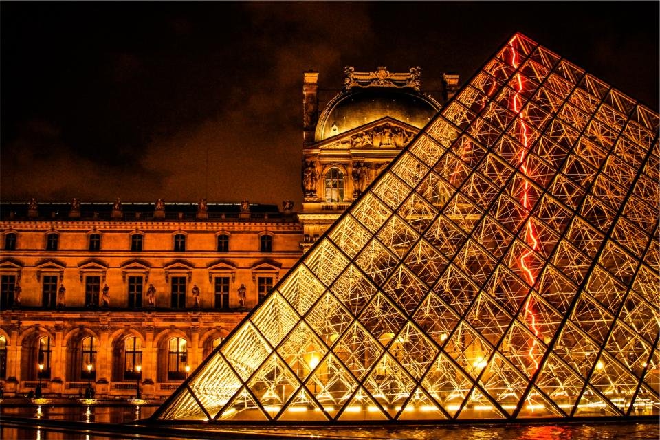 The Louvre pyramid lit up at night