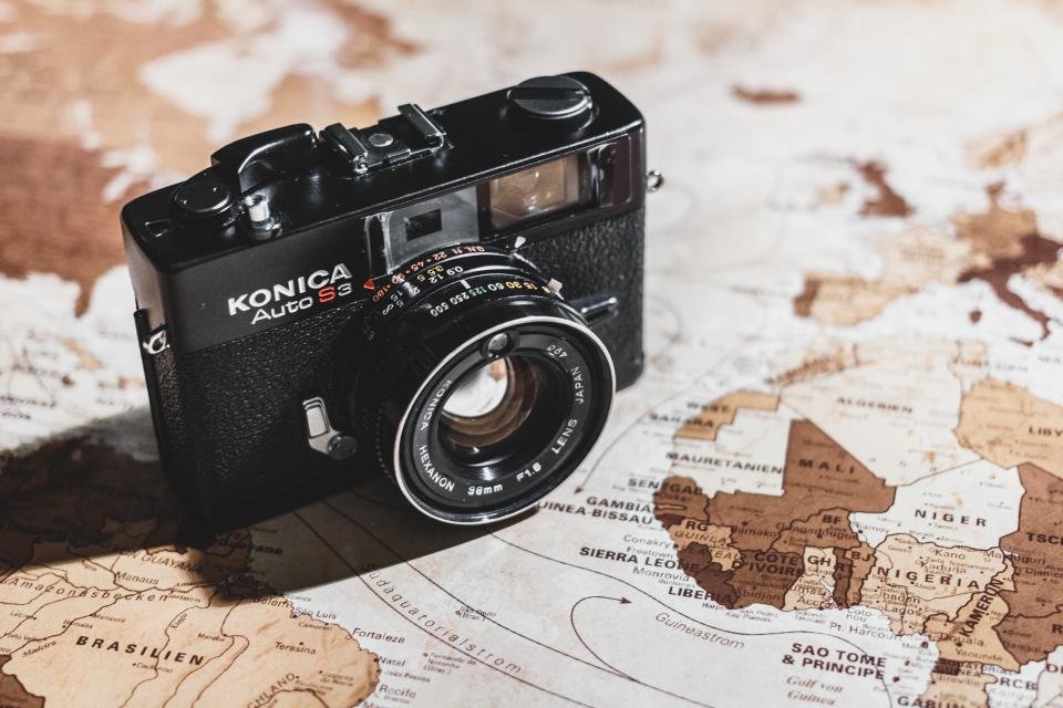 A vintage camera resting on a map