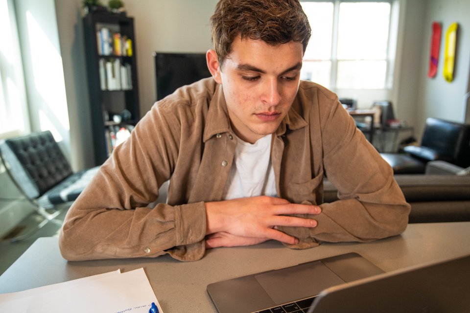 A young man concentrating at his desk