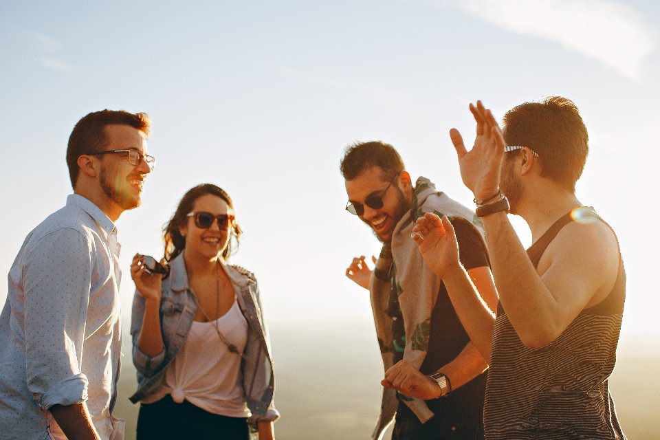 A group of friends laughing together outdoors