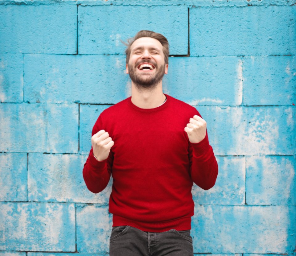 A young man celebrating with clenched fists